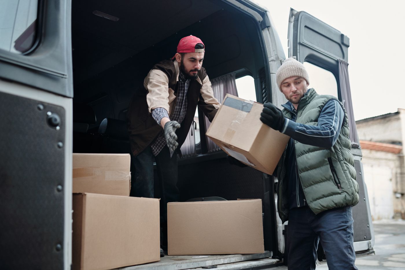 Removal team loading boxes into the van